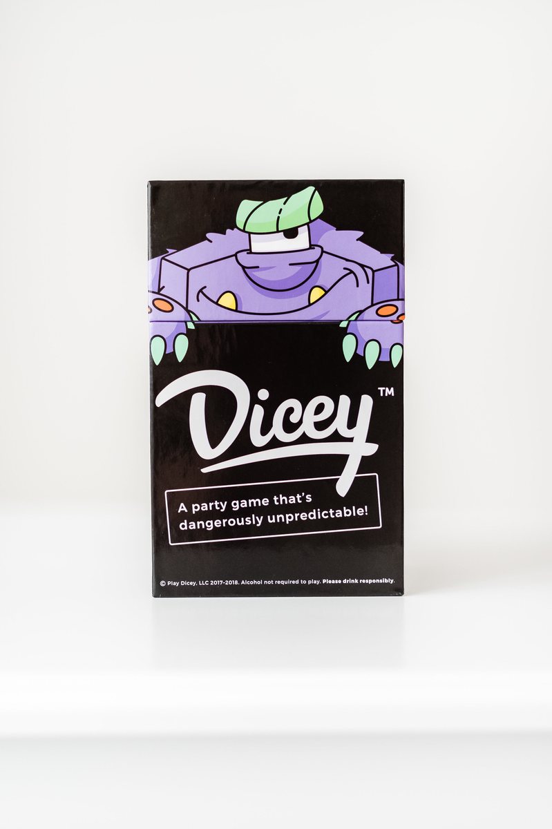 The black Dicey box on a white studio sweep, the purple monster peering over the top edge